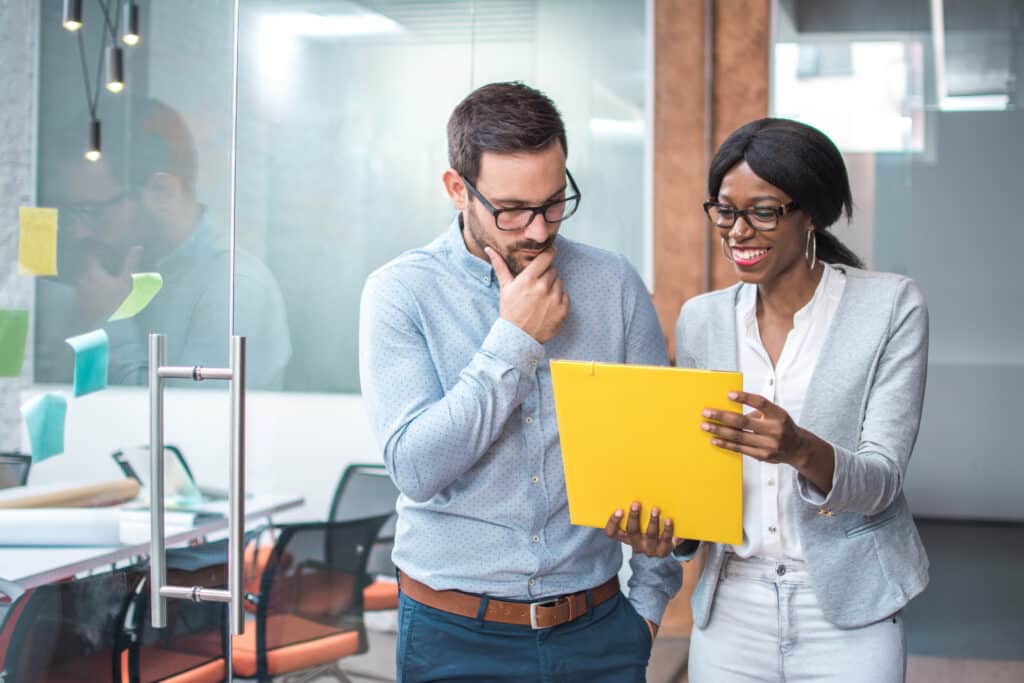 Two professionals reviewing report